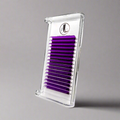 A tray of purple cashmere eyelash extensions arranged in rows in white tray on a gray background.
