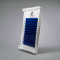 A tray of royal blue cashmere eyelash extensions arranged in rows on a white background, packaged in a clear plastic case with a brand logo at the top with a gray background.