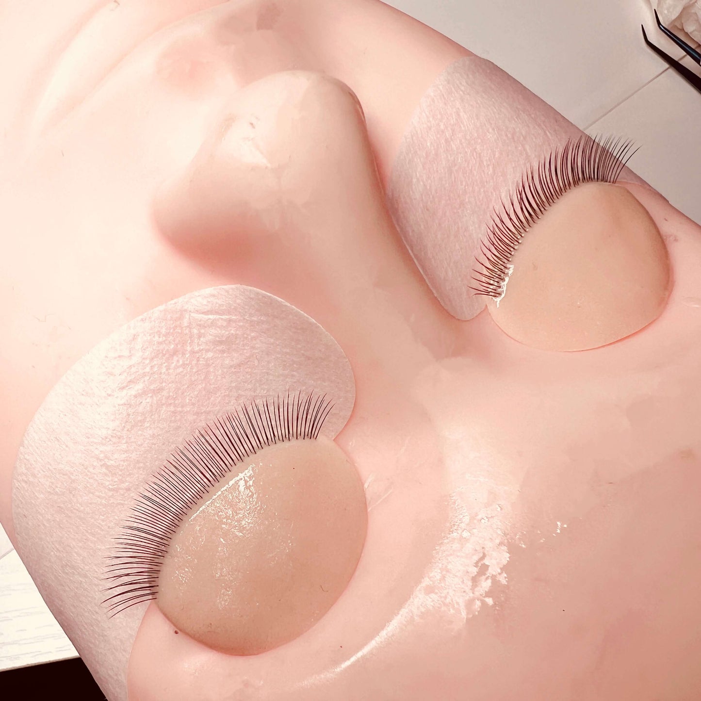False eyelashes on a doll's eyelid with a white background