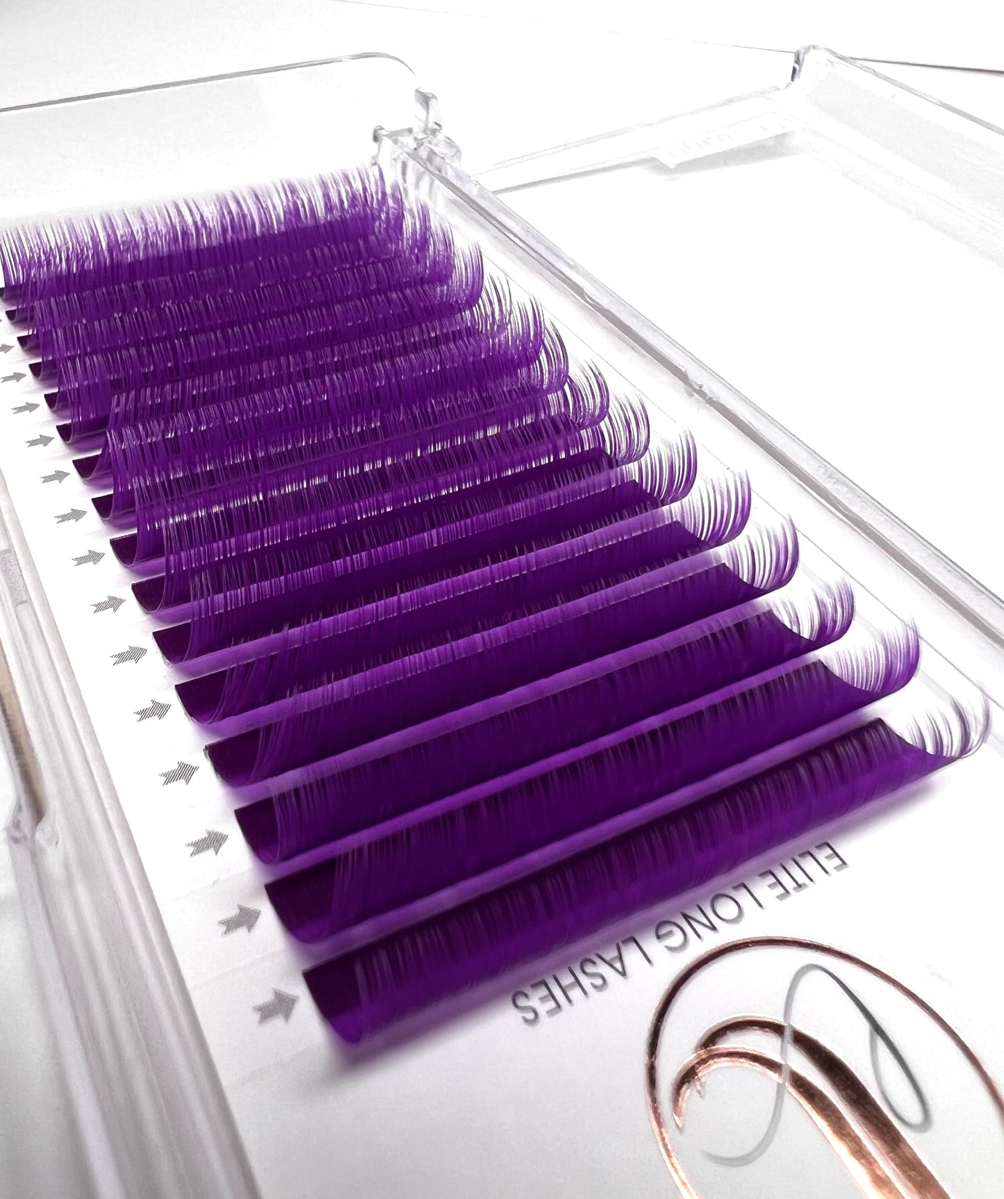 A tray of purple eyelash extensions. 16 lines of individual lashes.
