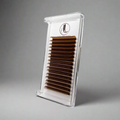 Clear container with brown false eyelashes on a gray background