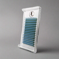 A tray of baby blue cashmere eyelash extensions arranged in rows on a white background, packaged in a clear plastic case with a logo at the top with a gray background