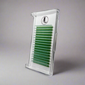 A tray of jade green cashmere eyelash extensions arranged in rows, protected by a clear plastic cover with a gray backround.