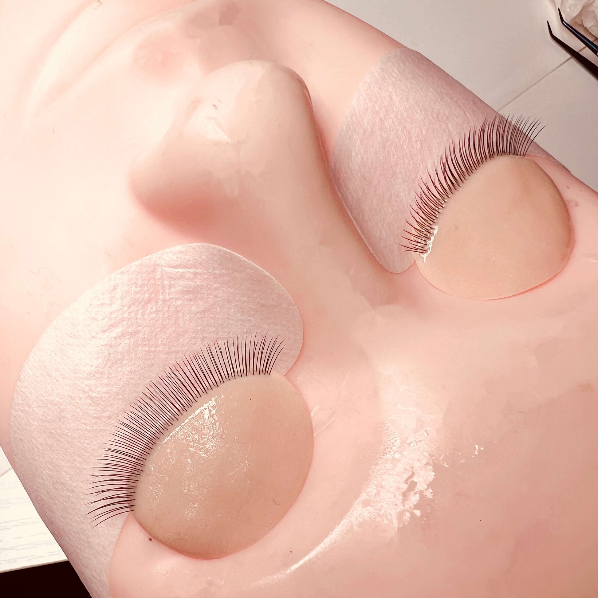 False eyelashes on a doll's eyelid with a white background