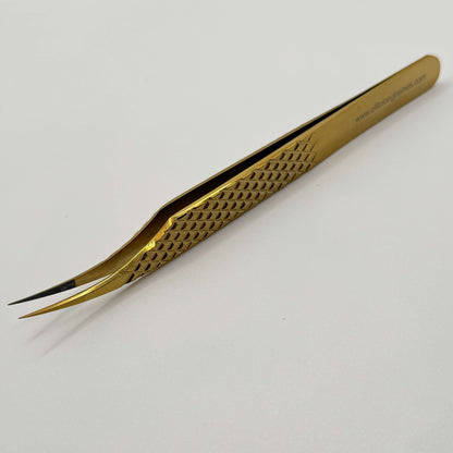 Gold tweezers with curve tips on a white background