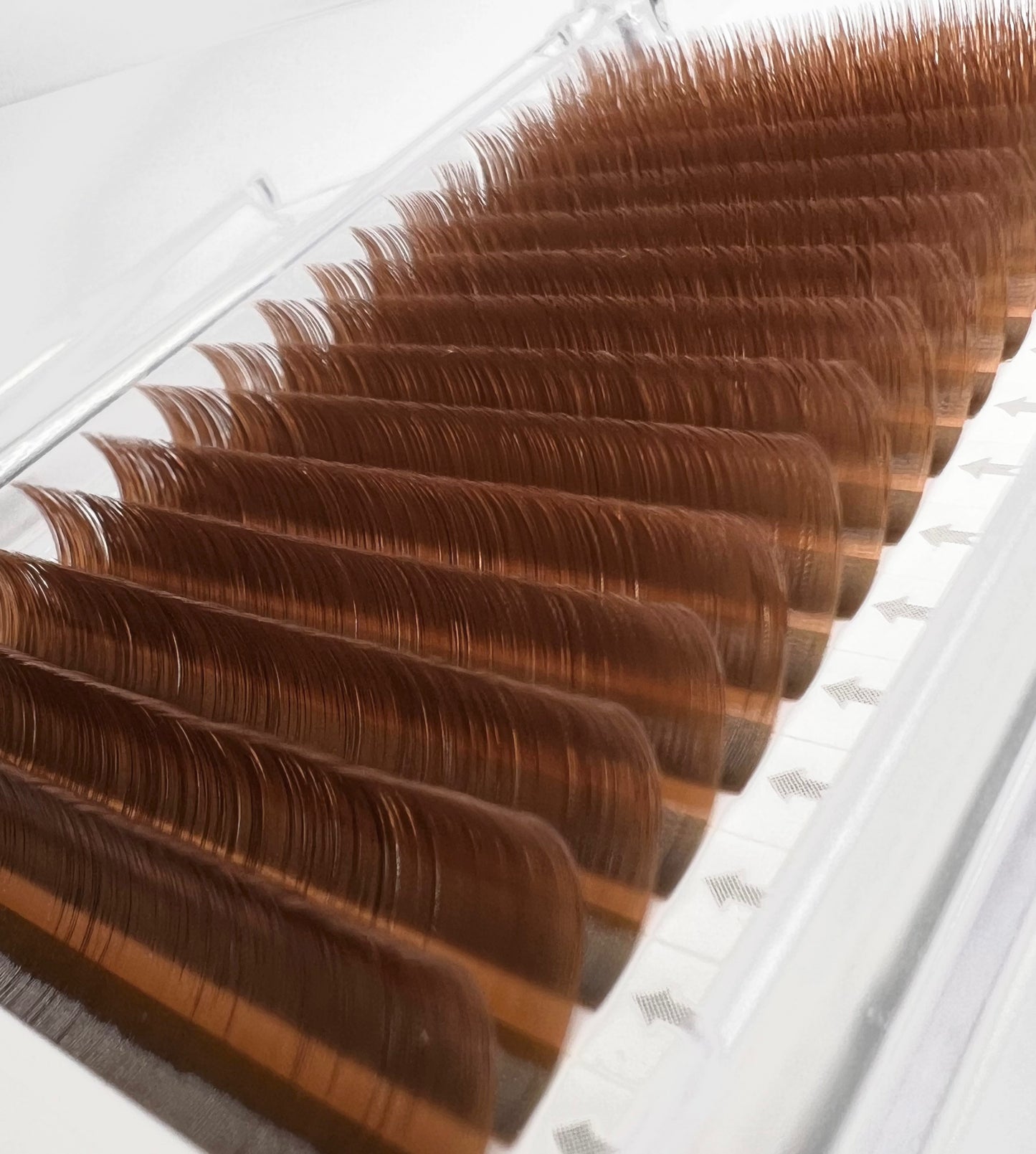 A tray of brown, matte mink eyelash extensions. 16 lash lines per tray.