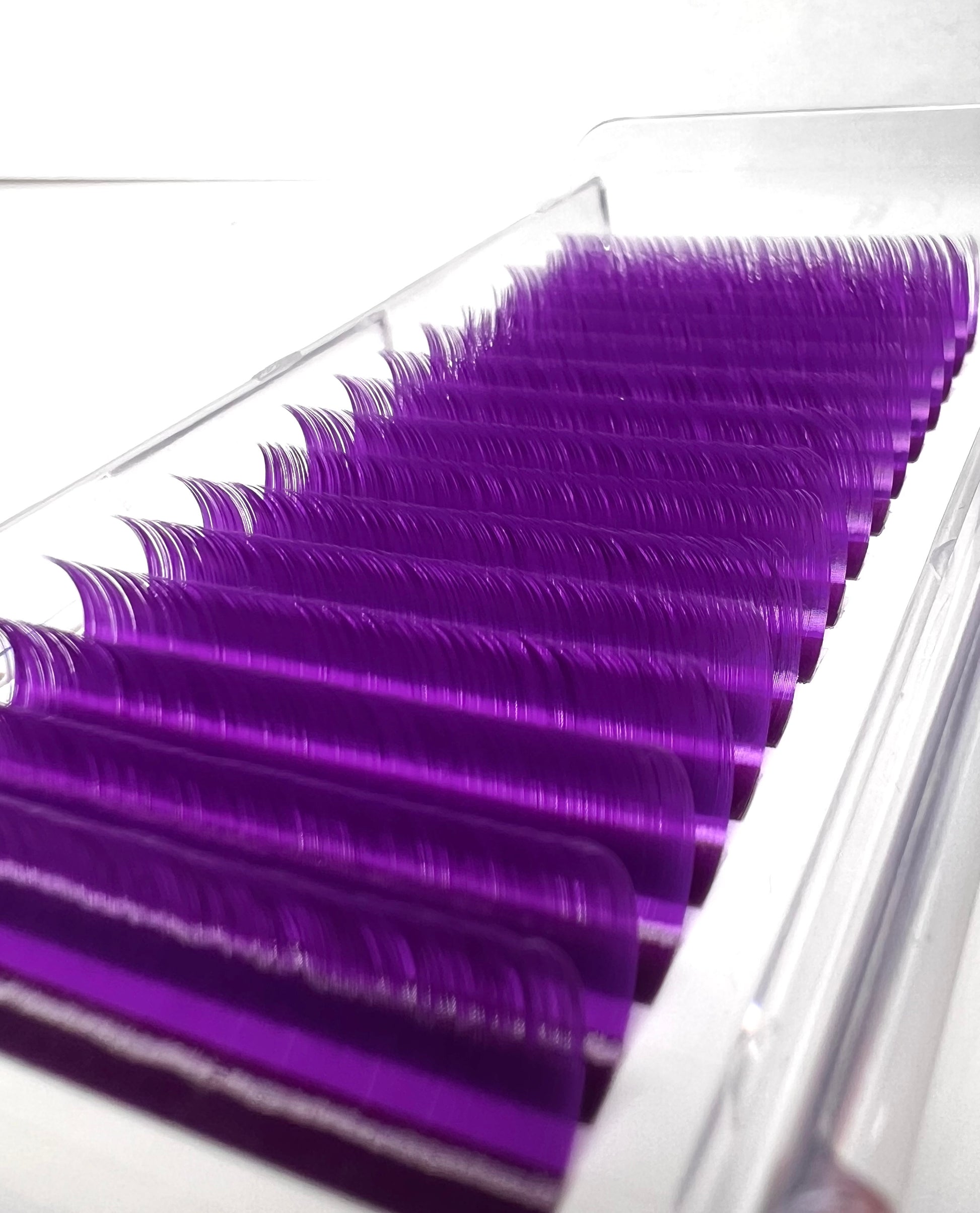 A tray of purple eyelash extensions. 16 lines of individual lashes. 