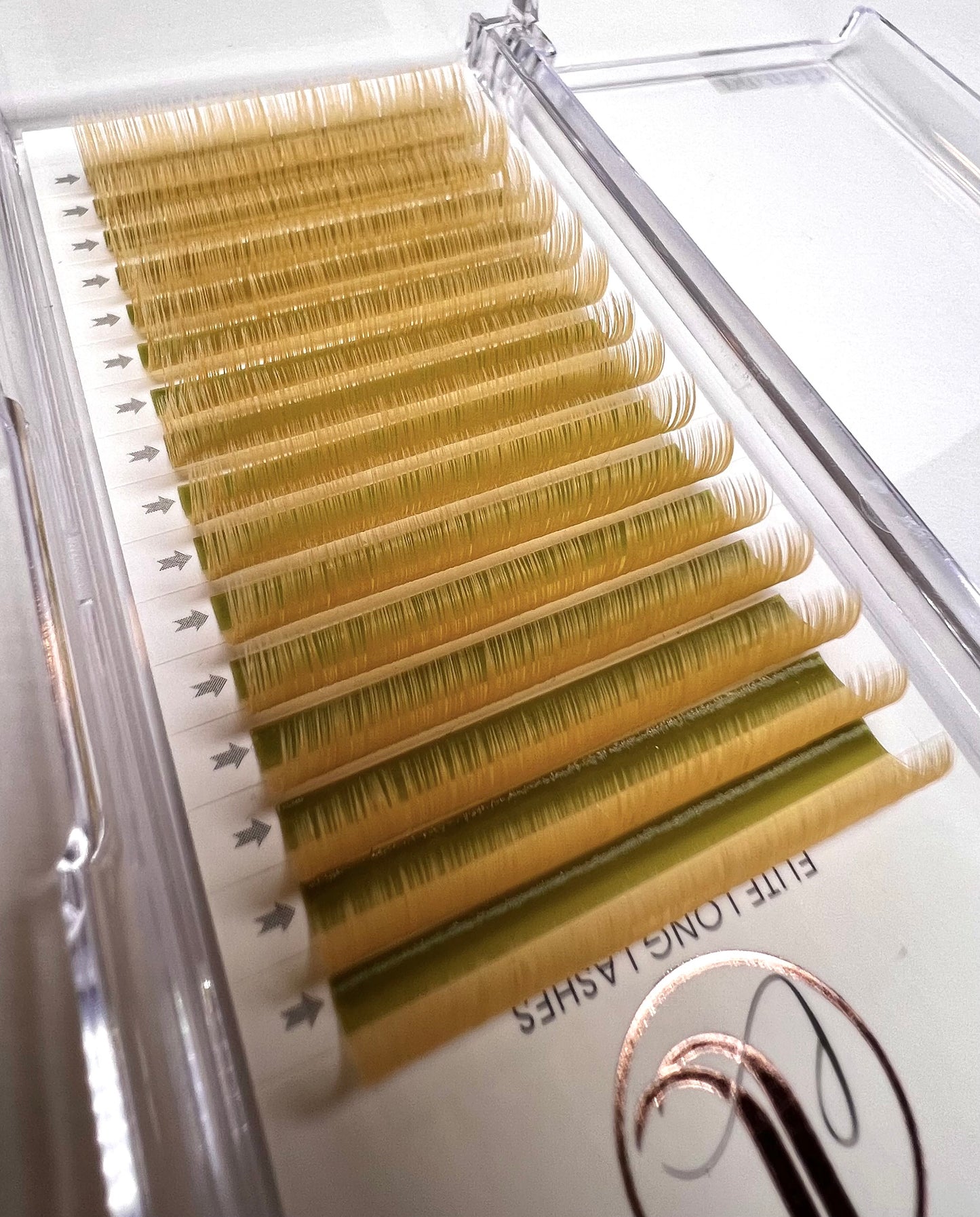 A tray of yellow, matte mink eyelash extensions. 16 lash lines per tray.