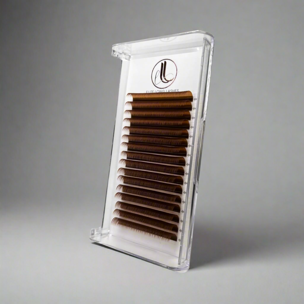 Clear container with brown false eyelashes on a gray background