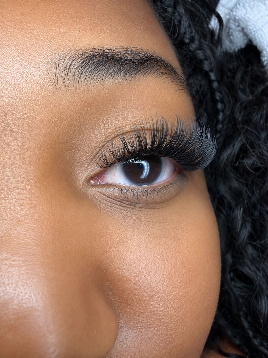 Close-up client eye wearing dramatic black lash extensions