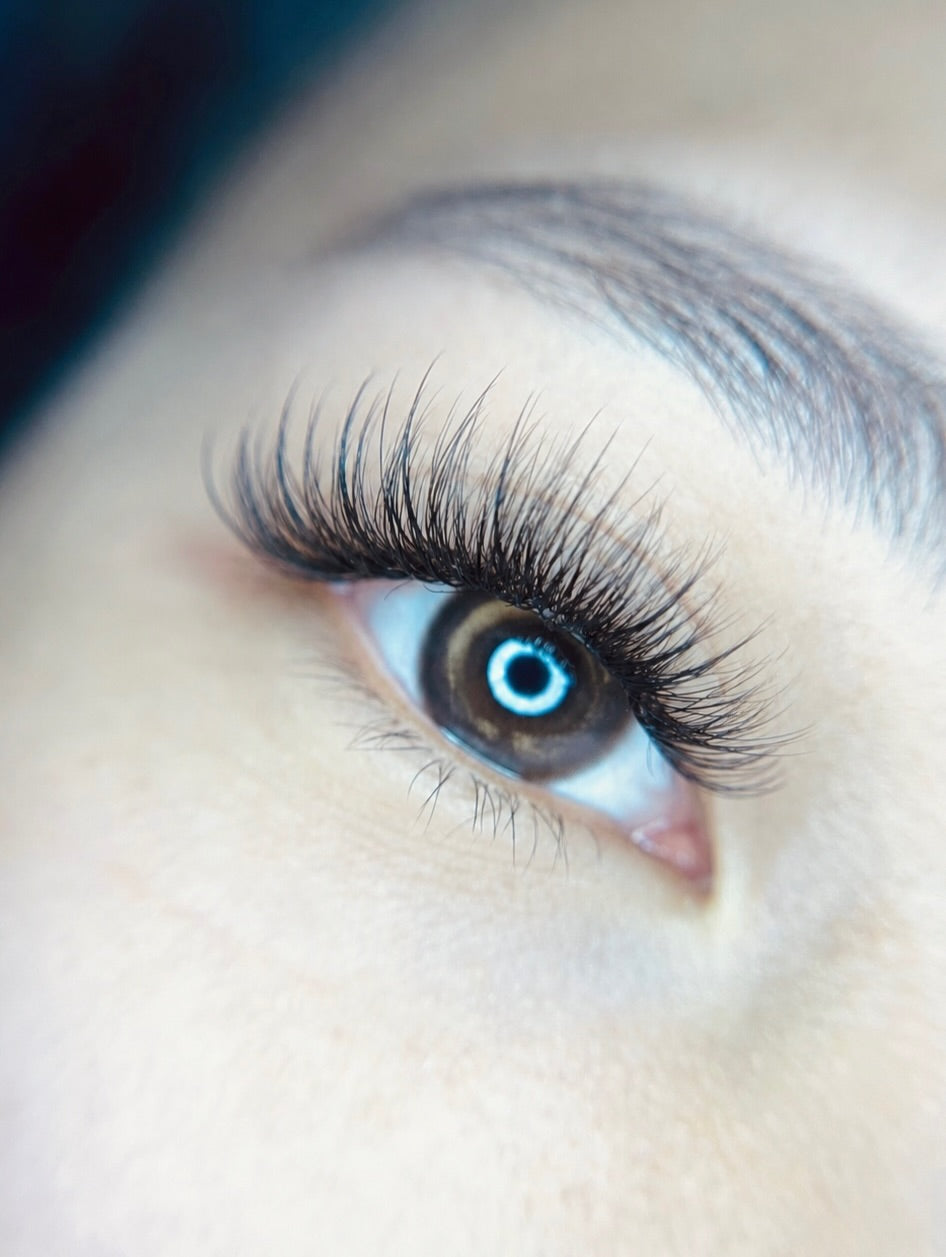 Close-up blue eye wearing Elite Long Lashes black lash extensions