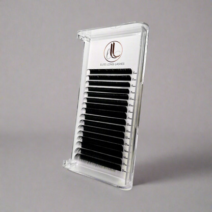 A tray of false eyelashes in a matte black color, displayed in a clear plastic case with a brand logo on the top.