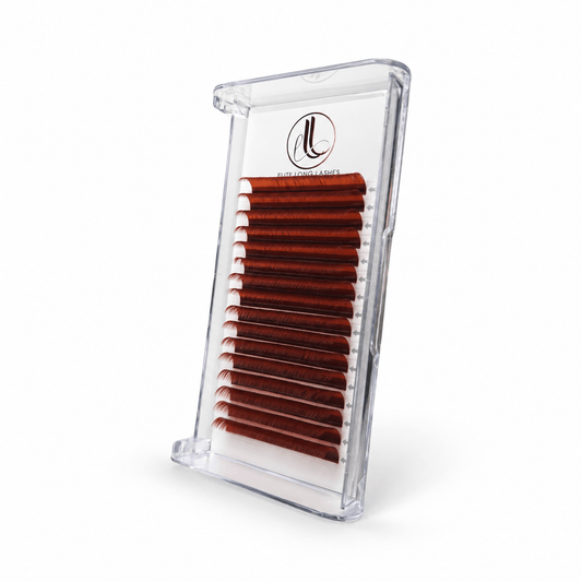 Elite Long Lashes copper red cashmere lash extensions arranged in rows in a clear tray on a soft white background.
