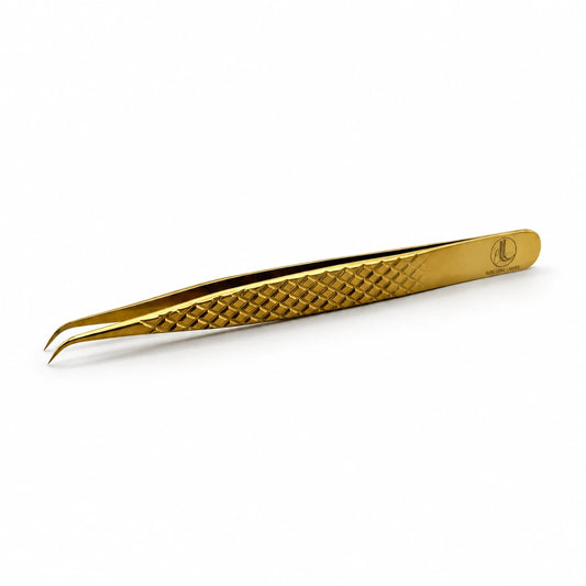 Elite Long Lashes Gold J-Curve 12cm isolation lash tweezer with a gold diamond grip and fine curved tips on a soft white background.