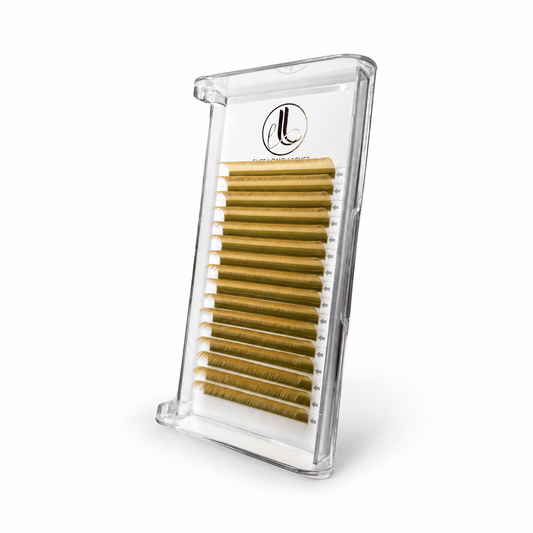 Elite Long Lashes yellow cashmere lash extensions arranged in rows in a clear tray on a soft white background.