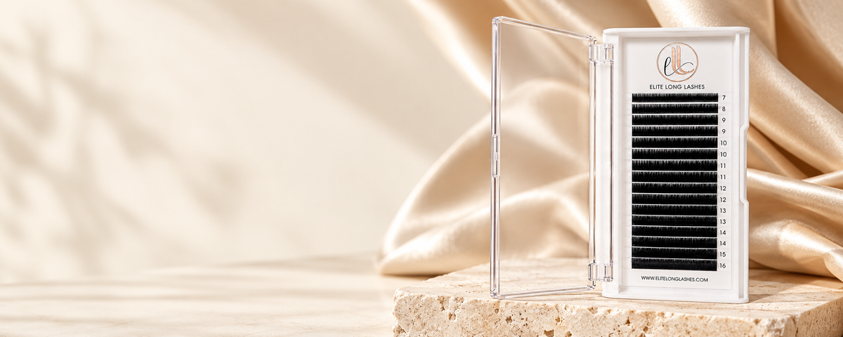 Open matte black lash tray with champagne satin and ivory stone