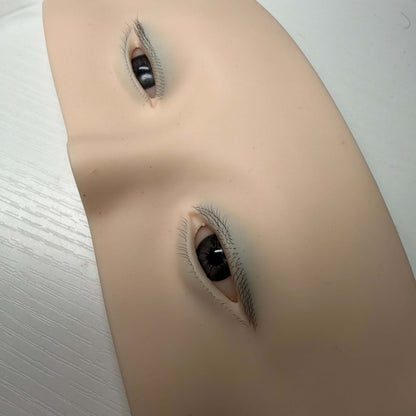 Silicone practice face for eyelash extension students showing eyes, brows and forehead detail